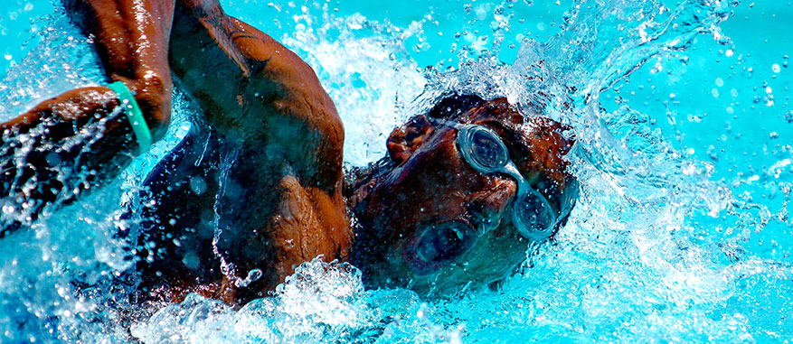 A local swimmer takes a quick breath of air during a 100m breaststroke